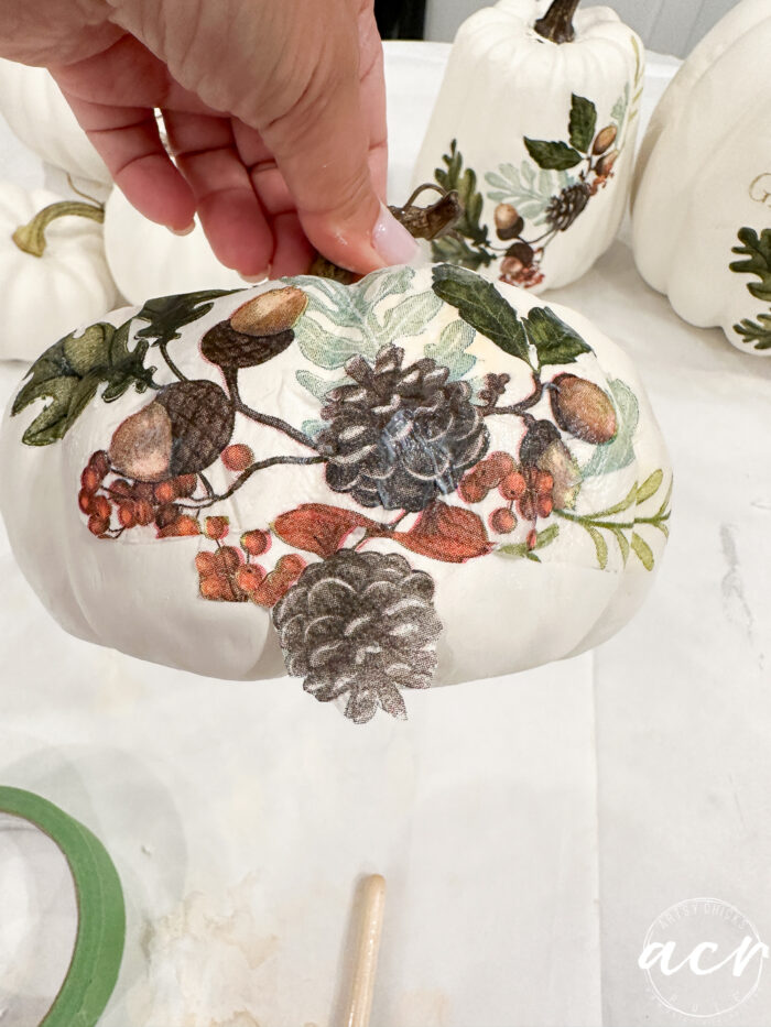 small pumpkin adding extra pieces of napkin to