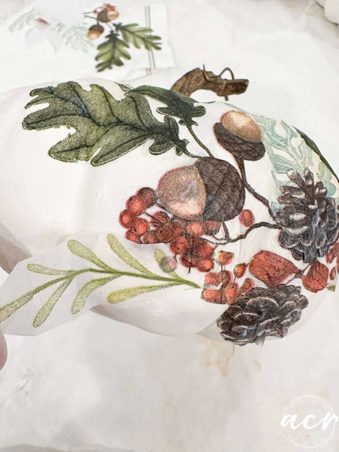 adding a green leaf to napkin design on pumpkin