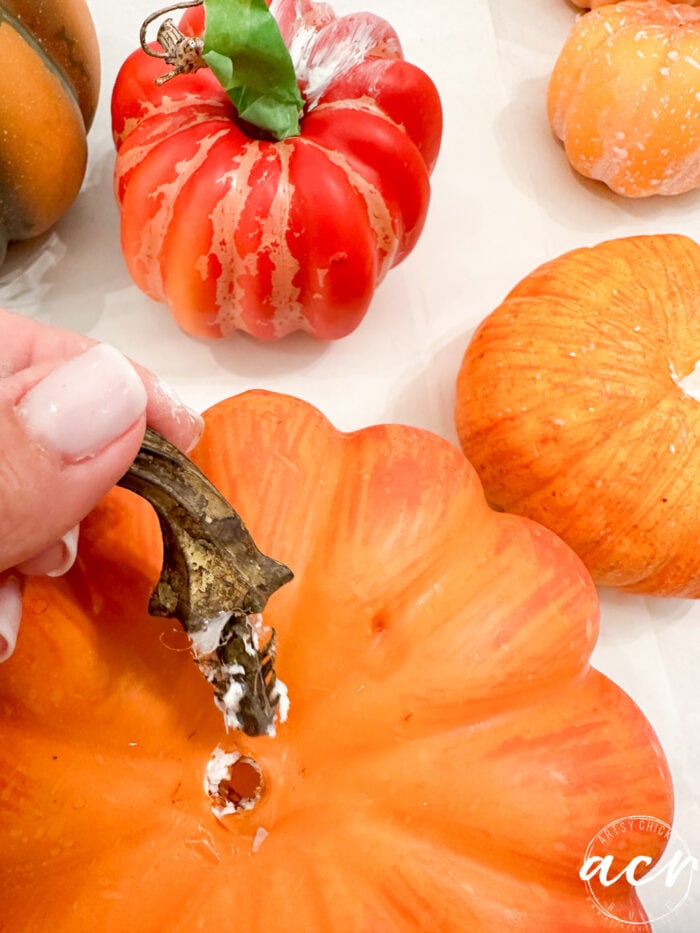 pulling stem out of orange pumpkin