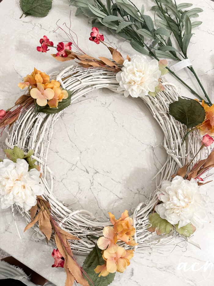 adding more flowers to wreath
