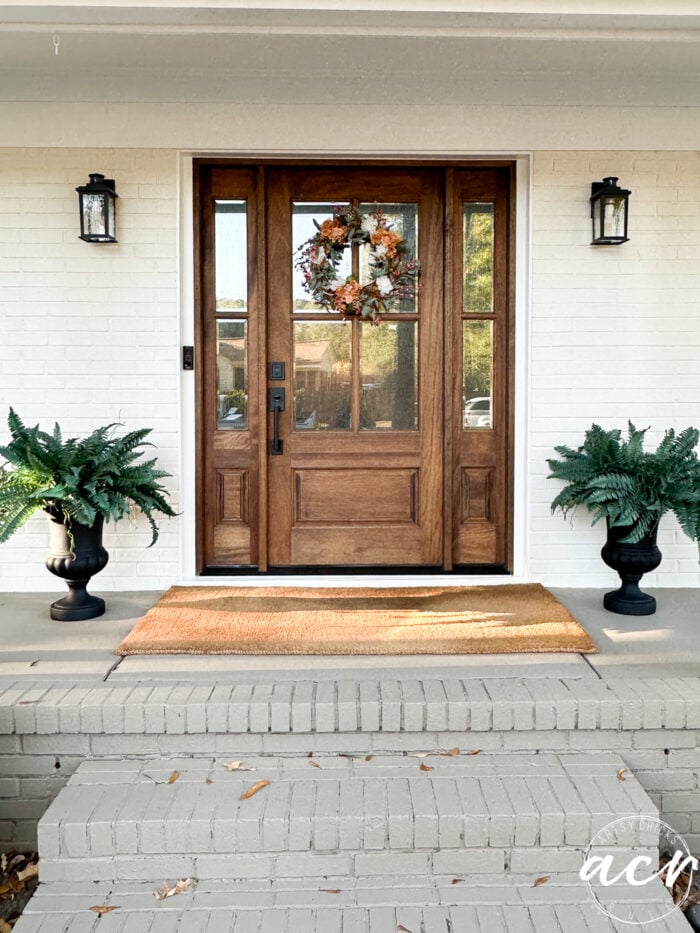 white duck brick exterior with walnut door