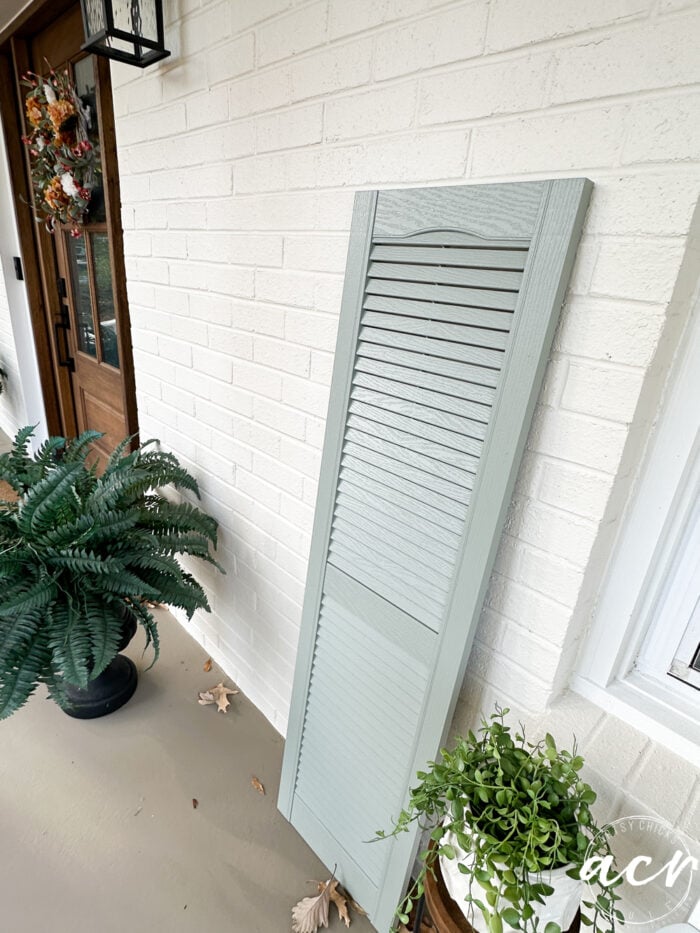 white duck brick home with aqua gray shutters
