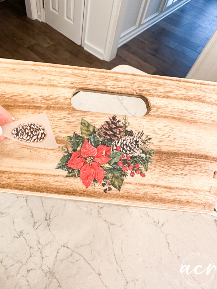 adding a pine cone transfer to poinsettia transfer on side of tray