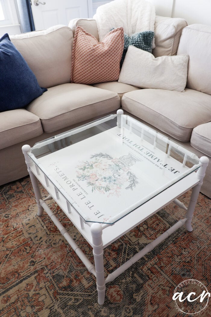 couch with pillows and white table with transfer