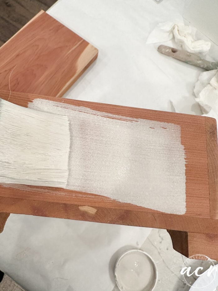 paint brush painting on watery paint onto box