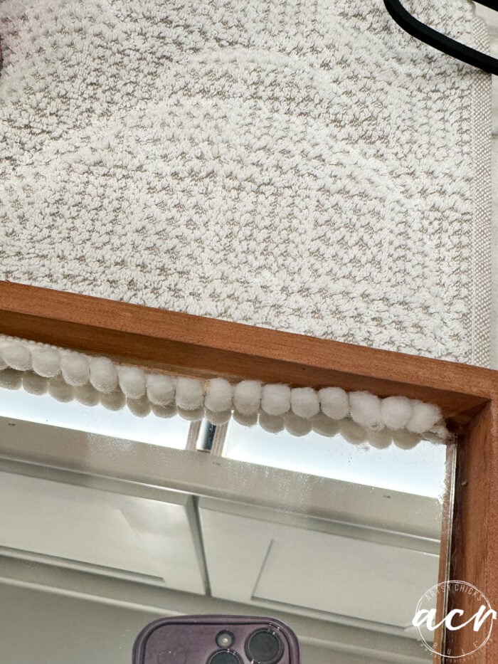 small round balls of garland around mirror