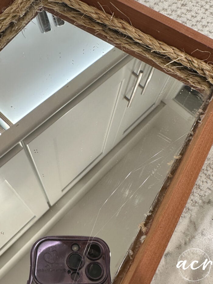 large frayed rope around mirror