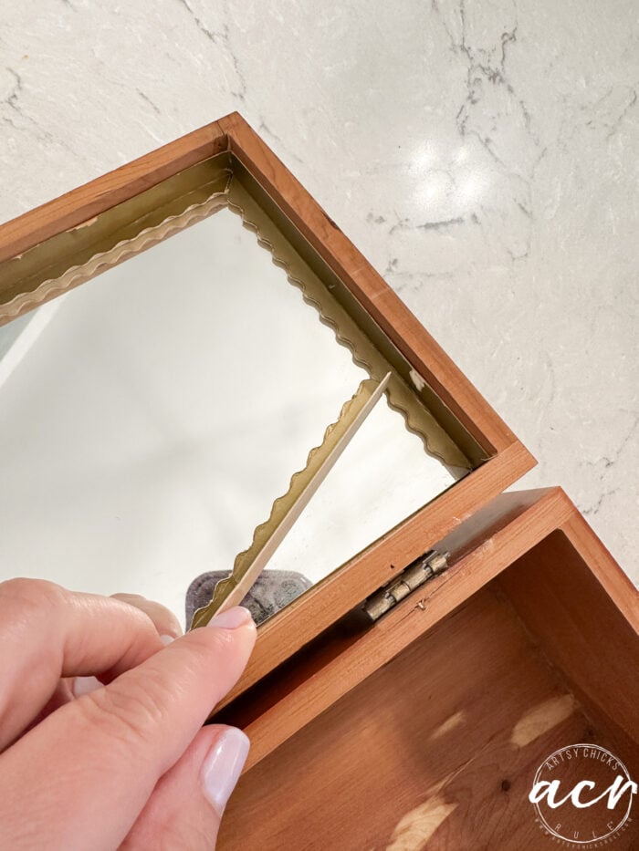 mirror with loose paper around it