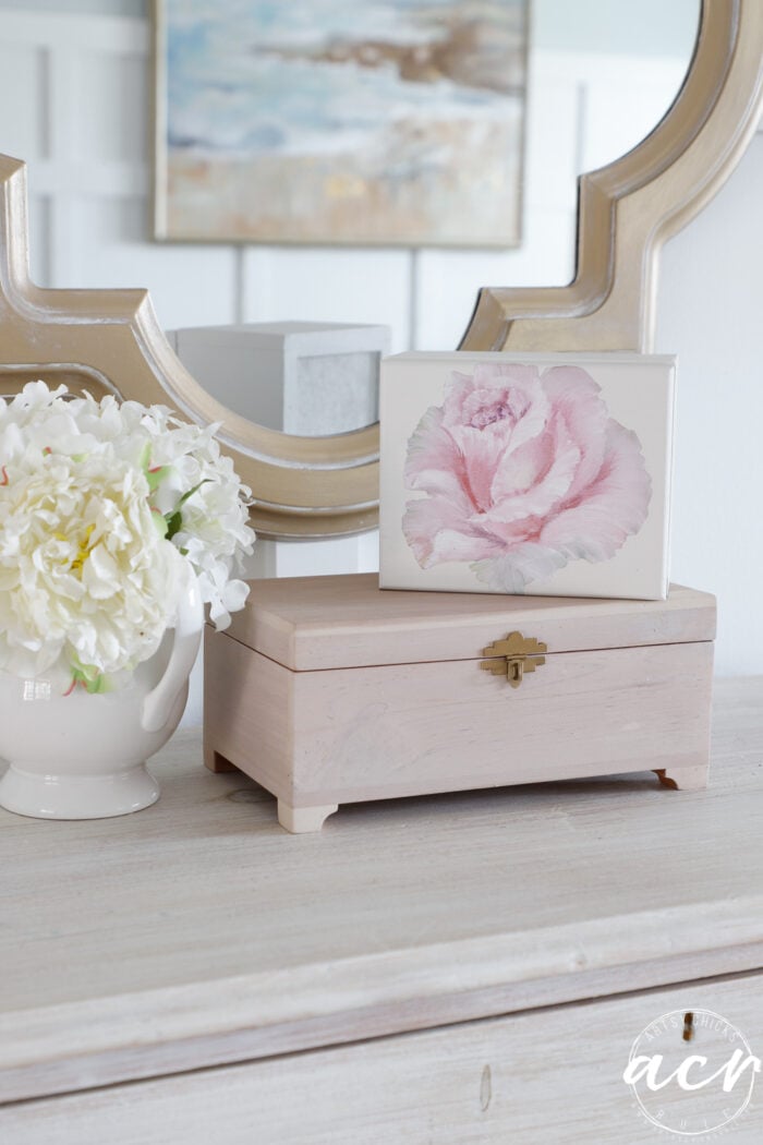 pink and white box sitting on top of cedar box