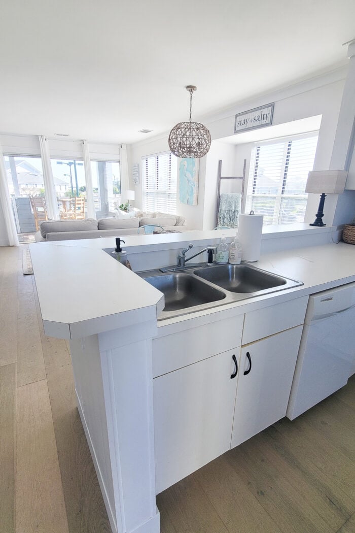 white kitchen overlooking living area