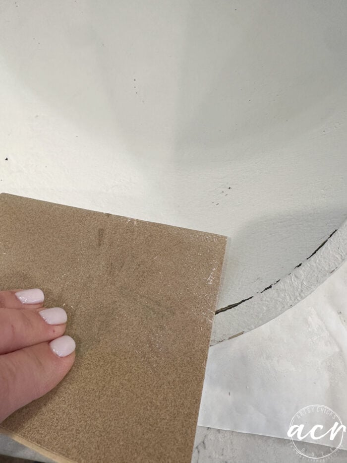 sanding edges of bowl