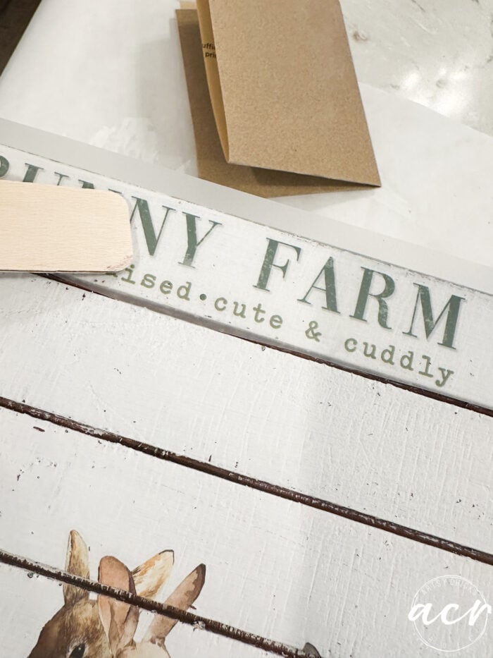 rubbing on the word transfer on top of crate