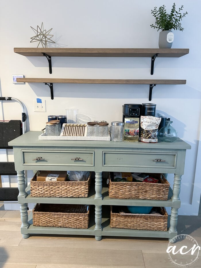 aqua console with baskets and shelves above