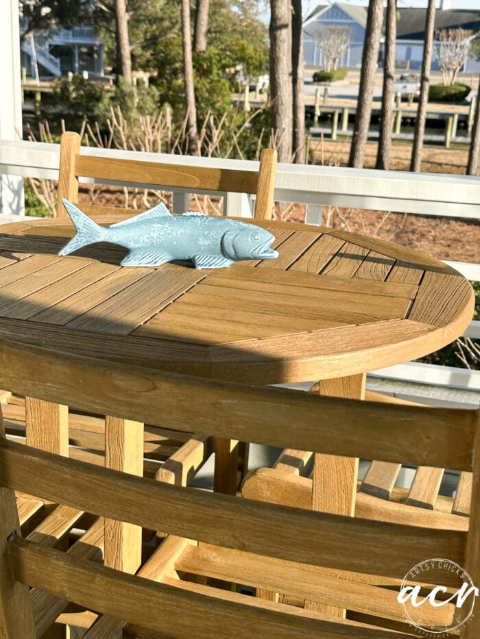 teak table and chairs with blue fish