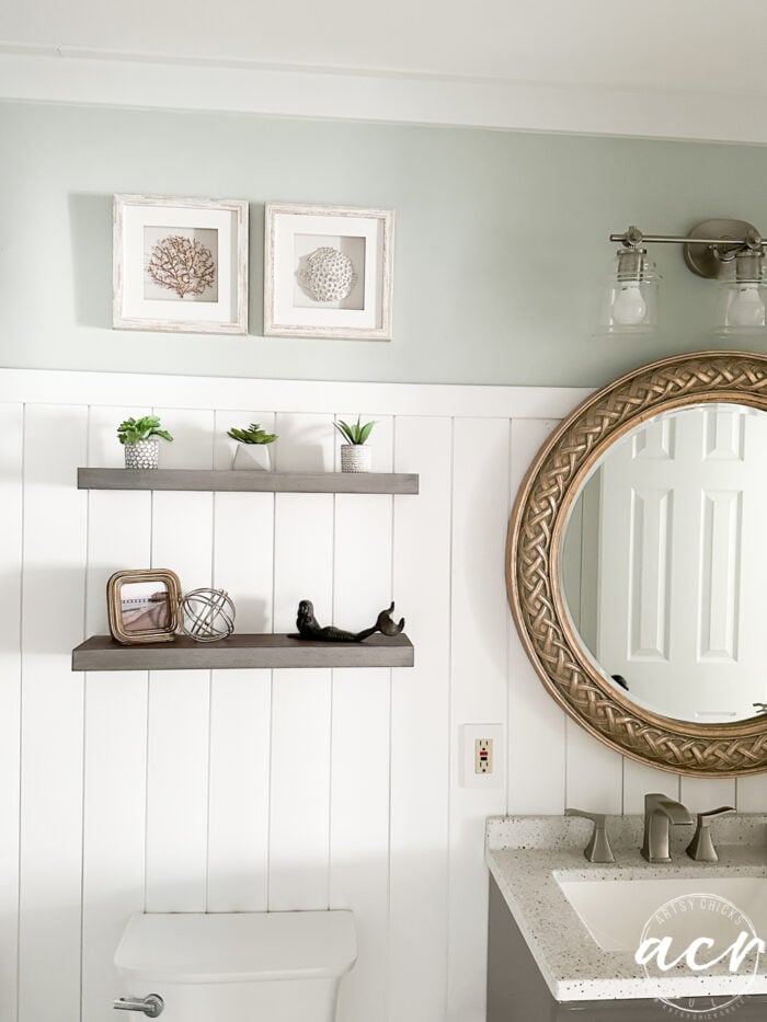 bathroom with round gold mirror
