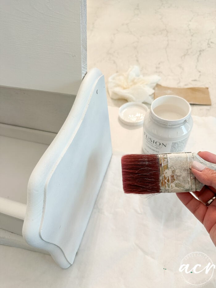 painting the side of the bread box with white paint