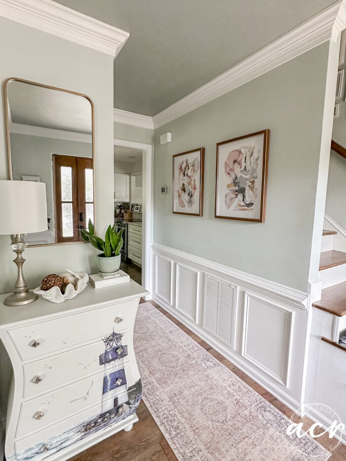 entire foyer view with stained prints and sea salt walls with oyster bay ceiling