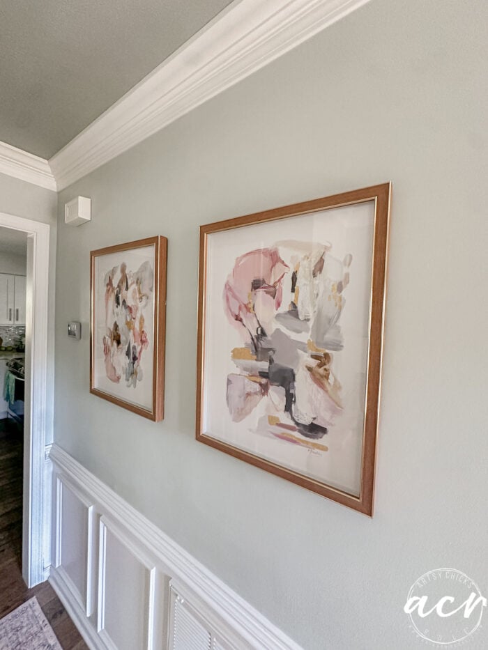 two framed prints hanging on wall