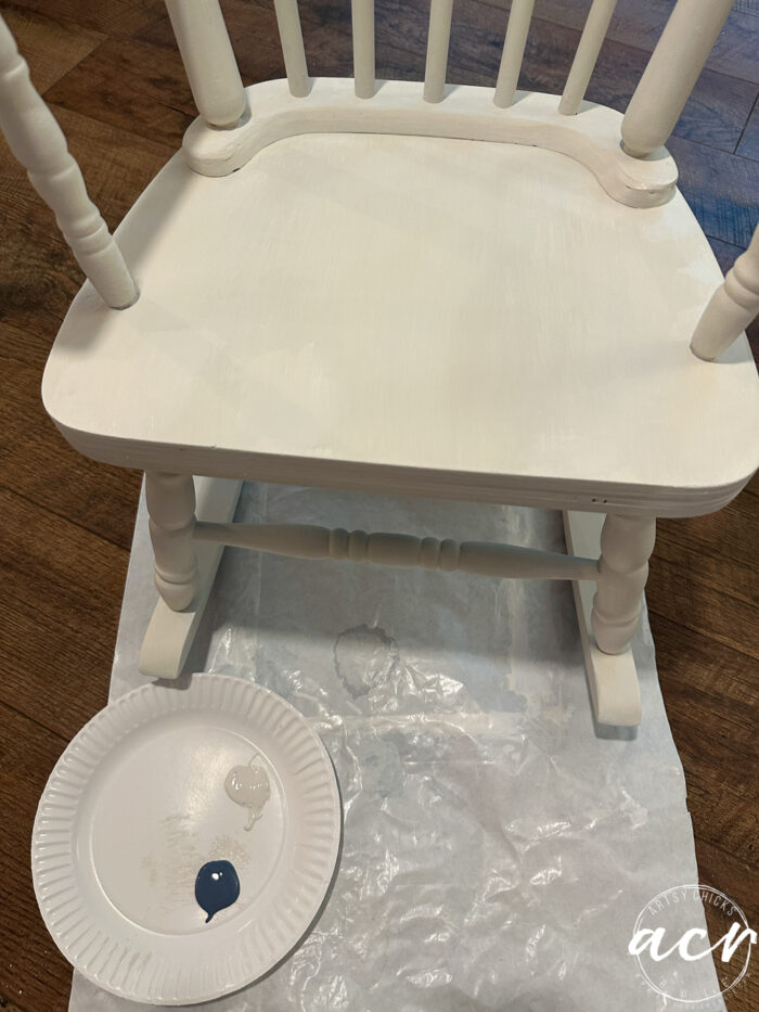 small white plate with white and blue paint