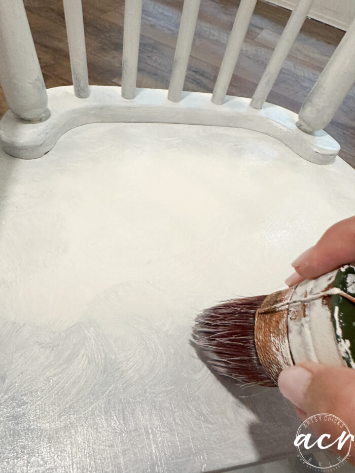 paintbrush adding the darker paint