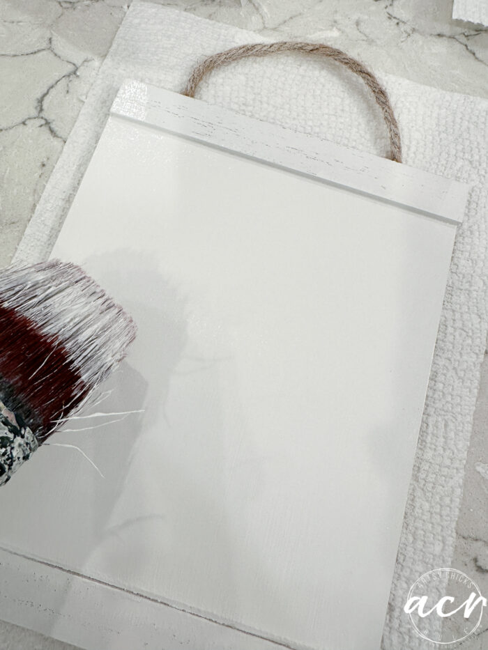 using brush to paint hanging art white