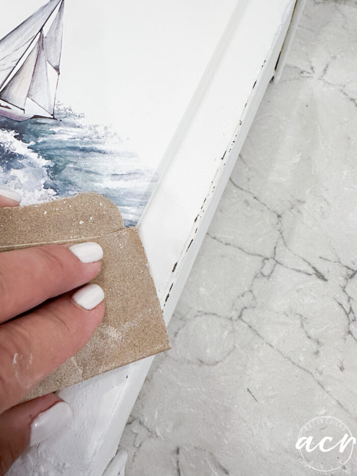 sanding edges of metal container 