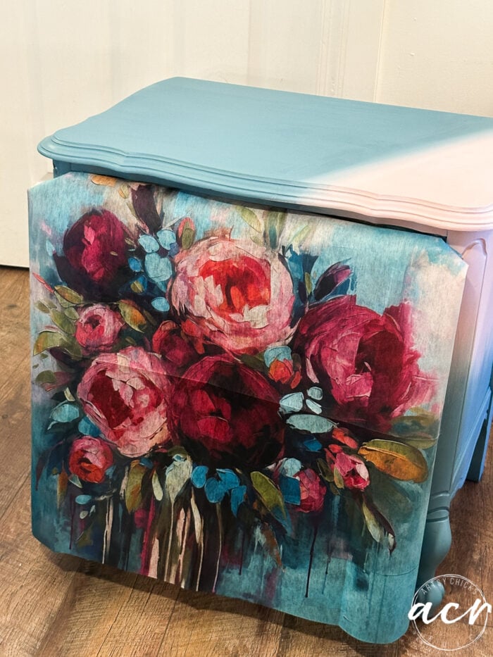 decoupage fiber laying on front with pink and blue top