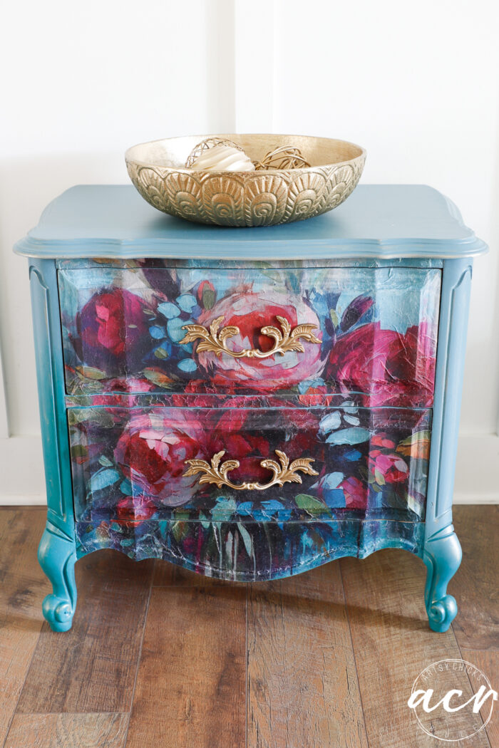 aqua night stand with colorful floral front and gold bowl on top