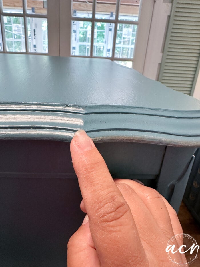 using finger to apply gold paint to edges