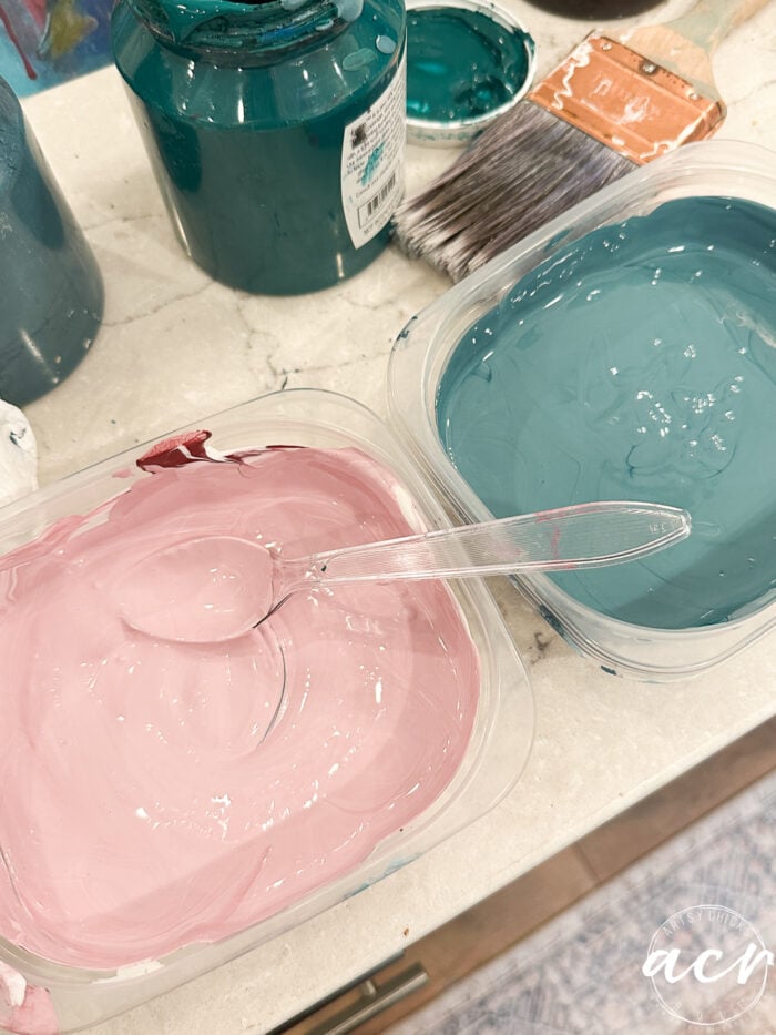 pink and aqua paint in dishes on counter