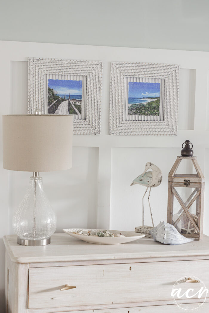 chargers on wall with prints over dresser and coastal decor