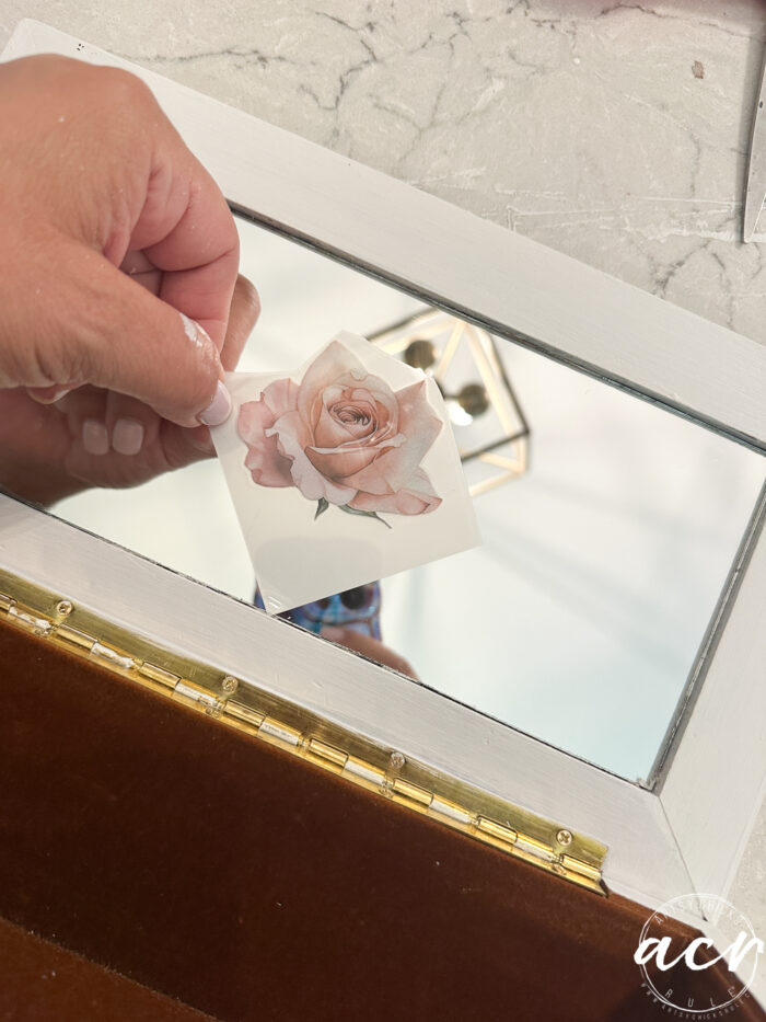 laying the other rose transfer on the center of the mirror inside