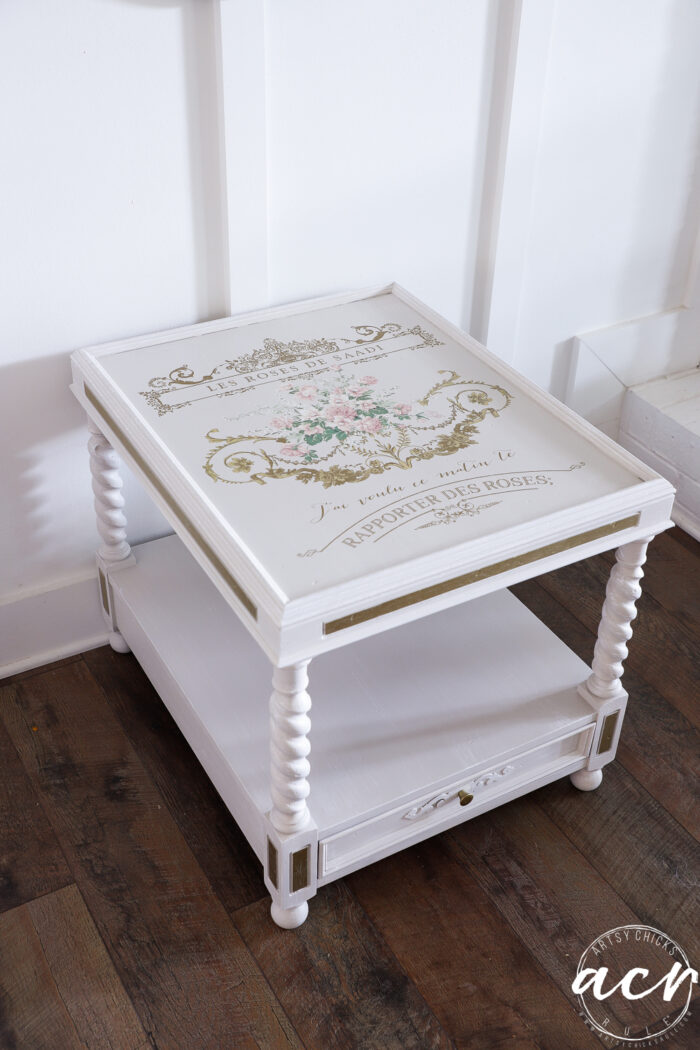 off white and gold table with pink floral and gold script transfer on top