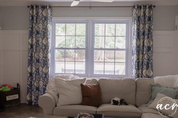 blue patterned curtains hanging around window