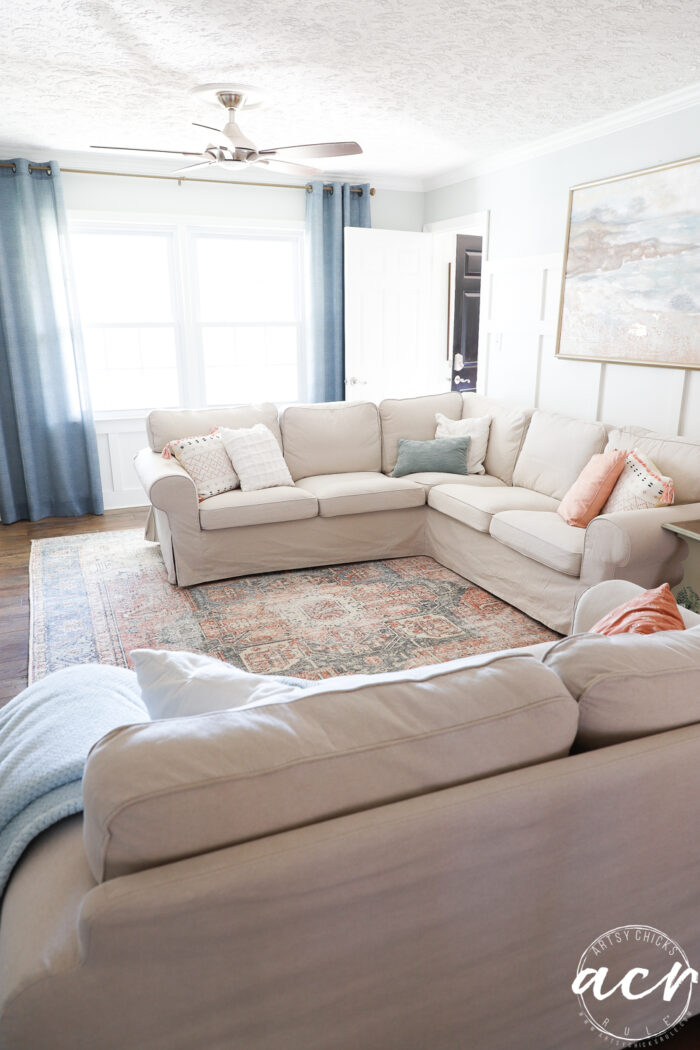 blue curtains, tan couch, colorful couch