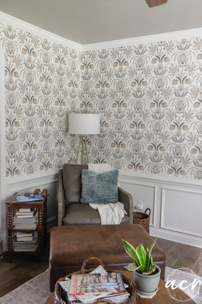 finsihed wallpaper in corner with leather chair and lamp