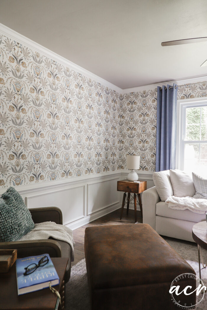 finished wallpaper with furniture and blue curtains and painted ceiling