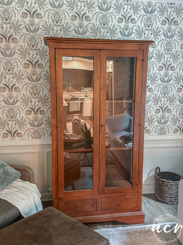 wood and glass cabinet with shelves
