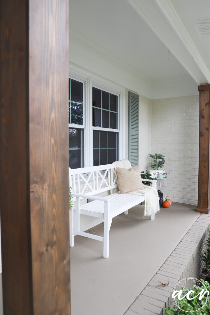 white bench on porch with wood columns