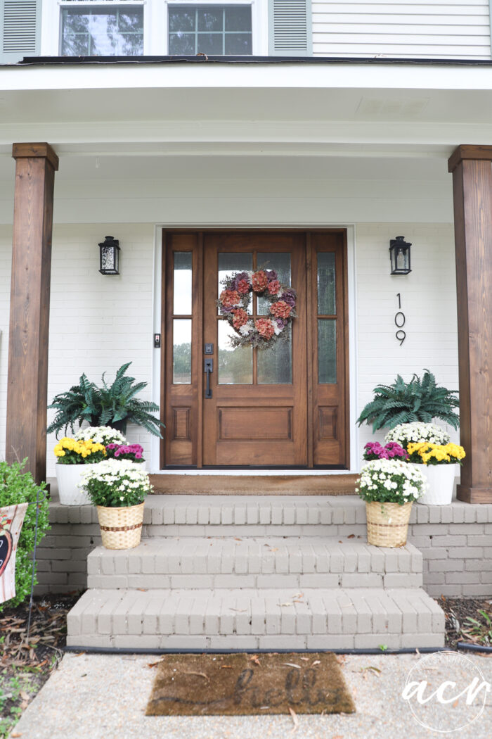 wood front door and wood columns