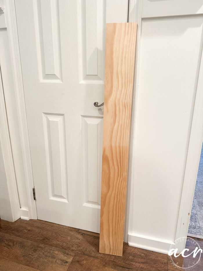 unfinished board leaning against the wall