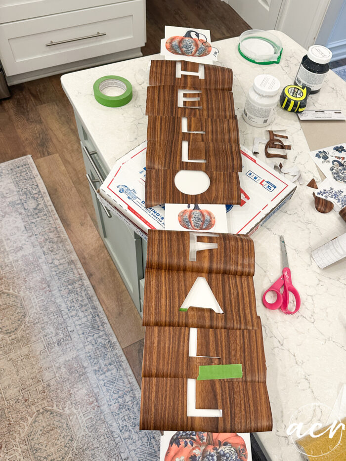 vinyl letter cutouts laying on board