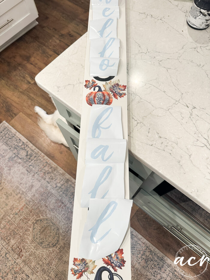 white board sign with letter cutouts that are script font