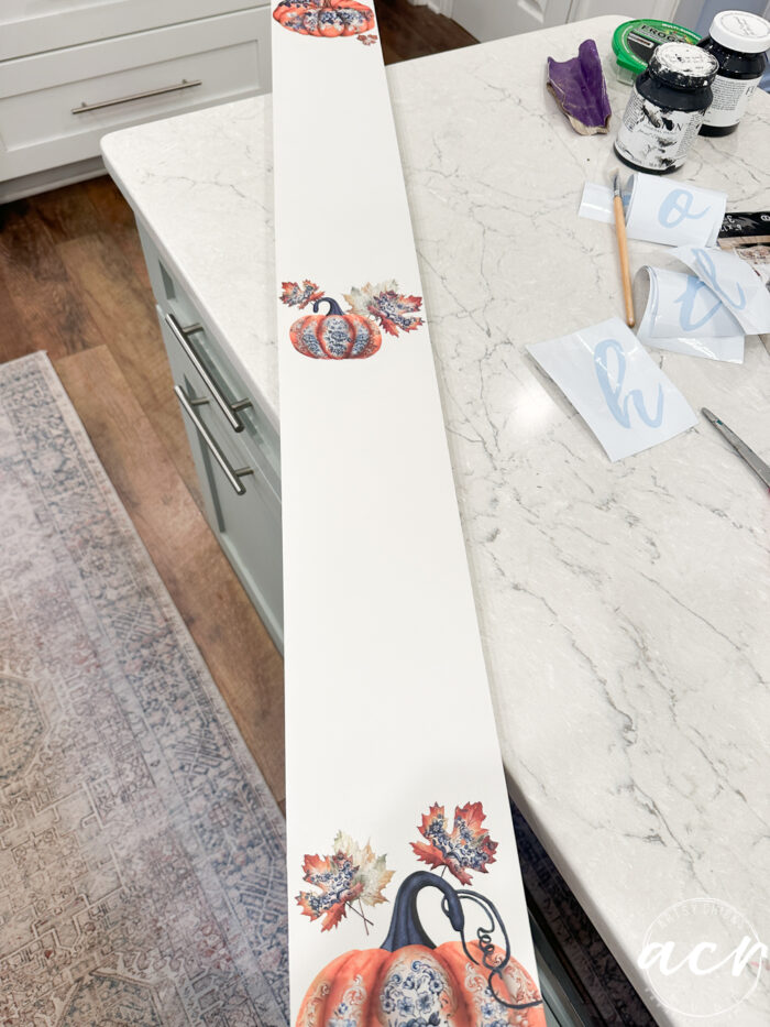 white board sign painted white with pumpkin transfers