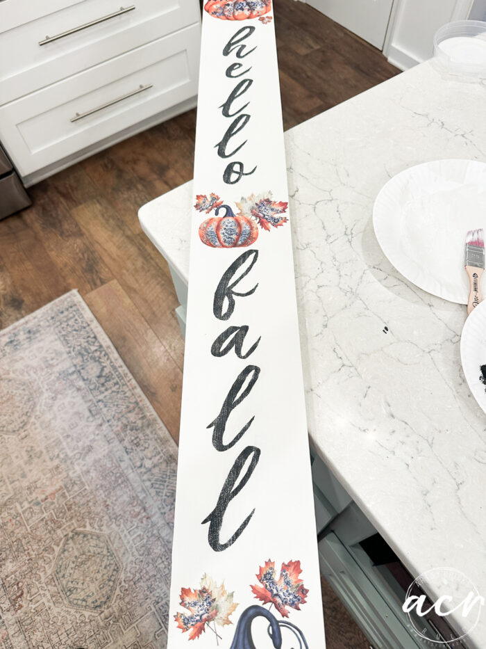 soft, script font lettering painting onto board