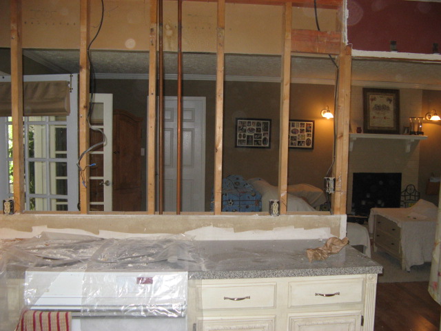 kitchen wall looking into living room with only studs