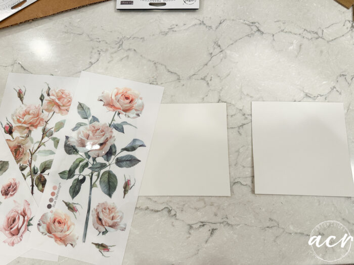 pink rose transfers laying beside two white squares