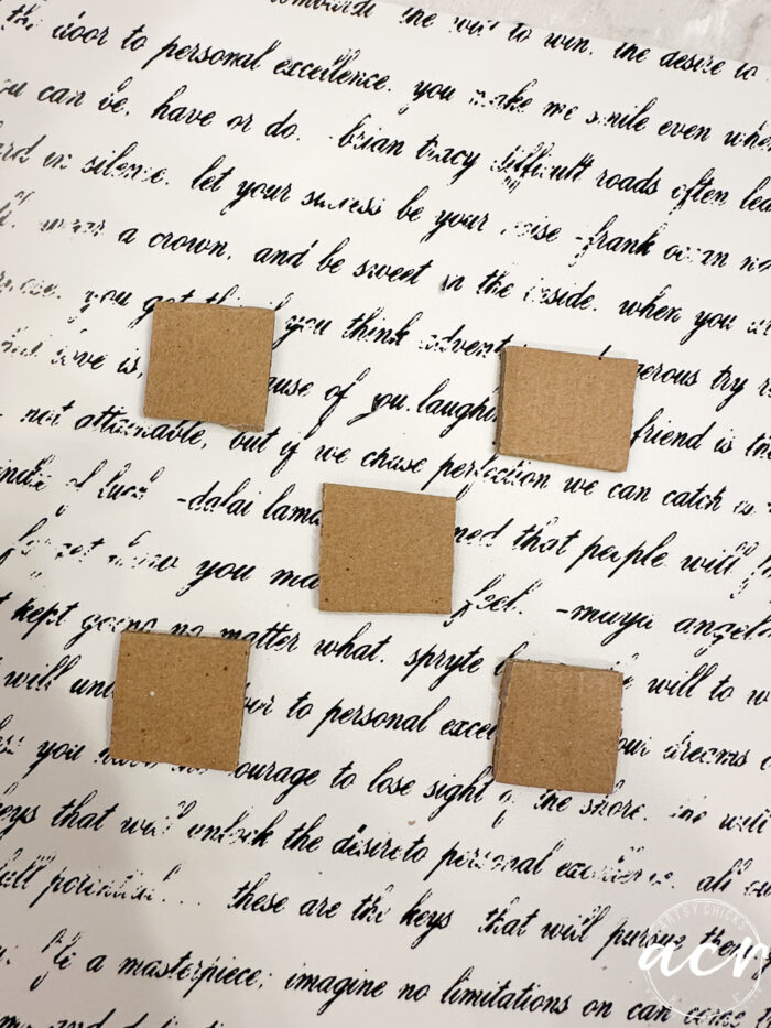 small cardboard pieces on script print
