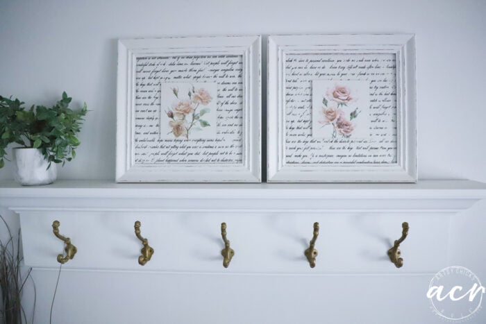 framed artwork on shelf above hooks