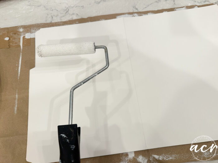 roller painting the folder white